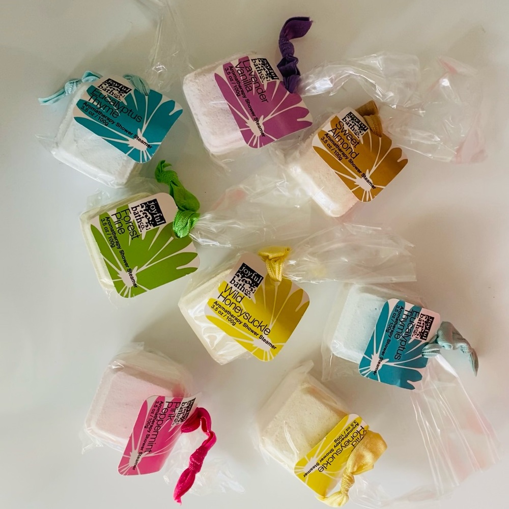 Joyful Bath Aromatherapy shower steamer, assorted, with hair tie.